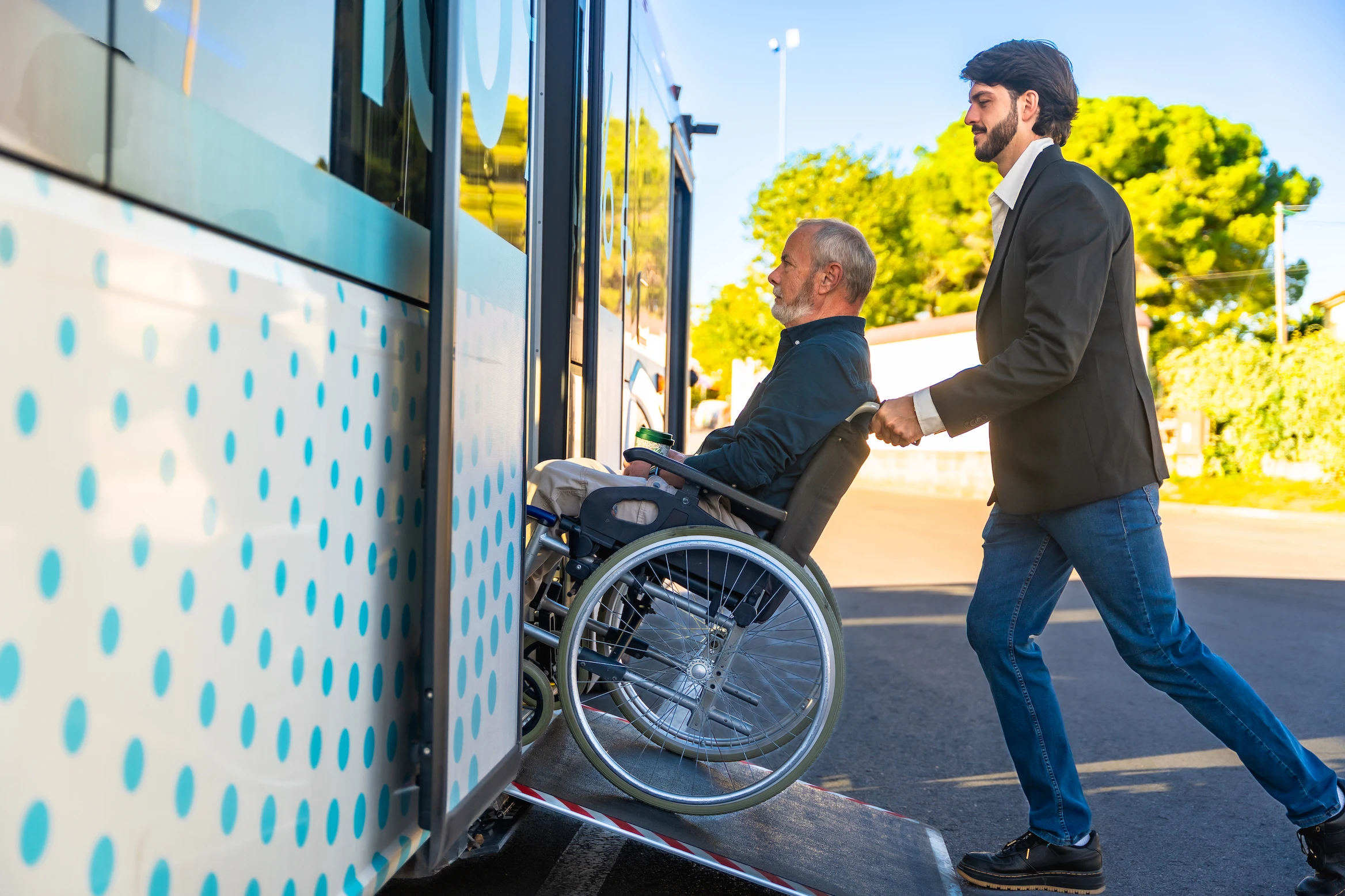 man-helping-senior-with-wheelchair-boarding-the-bu-2026-03-26-23-26-51-utc