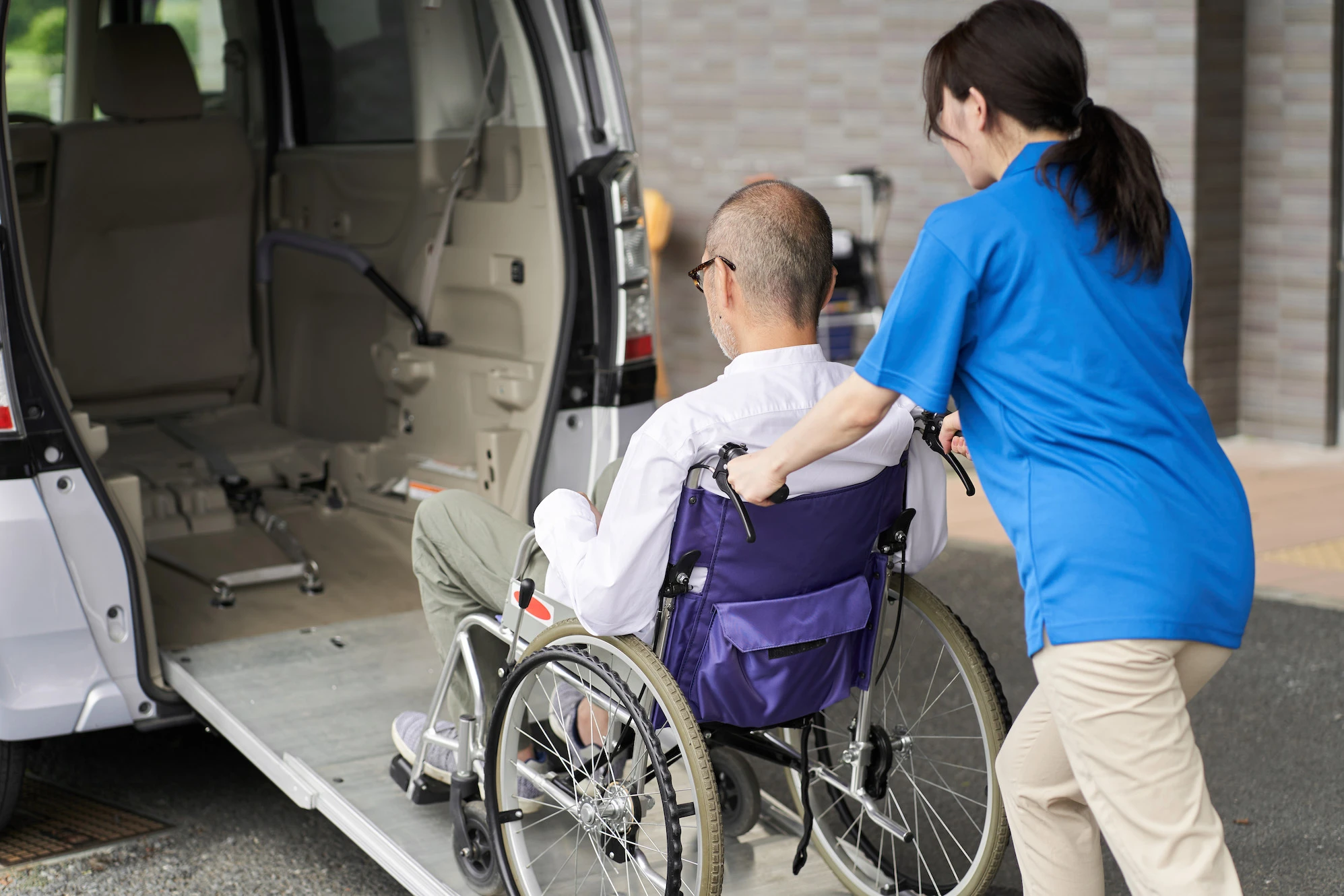 woman-assists-man-in-wheelchair-into-van-2026-03-24-00-36-26-utc